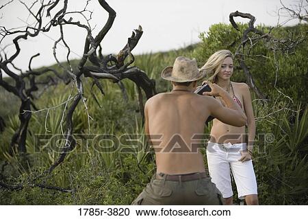 Man photographing scantily clad woman View Large Photo Image Stock Image - Man photographing scantily clad woman. Fotosearch