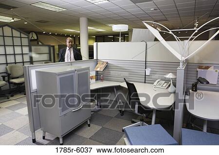 Mature businessman inspecting office cubicles View Large Photo Image Stock Photo - Mature businessman inspecting office cubicles. Fotosearch