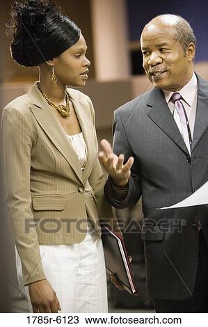 Mature businessman talking to a younger woman View Large Photo Image Stock Image - Mature businessman talking to a younger woman. Fotosearch