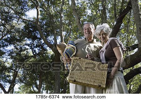 Picture - Mature couple going on a picnic. Fotosearch