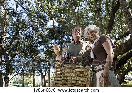 Mature couple going on a picnic View Large Photo Image Stock Image - Mature couple going on a picnic. Fotosearch