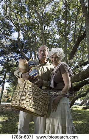Mature couple going on a picnic View Large Photo Image Stock Image - Mature couple going on a picnic. Fotosearch