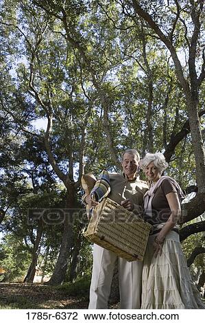 Mature couple going on a picnic View Large Photo Image Stock Image - Mature couple going on a picnic. Fotosearch
