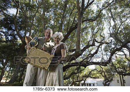 Mature couple going on a picnic View Large Photo Image Stock Image - Mature couple going on a picnic. Fotosearch