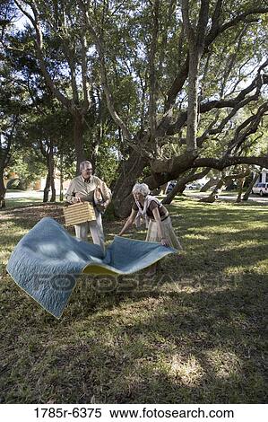 Stock Photography - Mature couple going on a picnic. Fotosearch