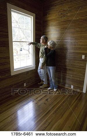 Mature couple in a darkened room leaning against window, gazing out View Large Photo Image Stock Image - Mature couple in a darkened room leaning against window, gazing out. Fotosearch