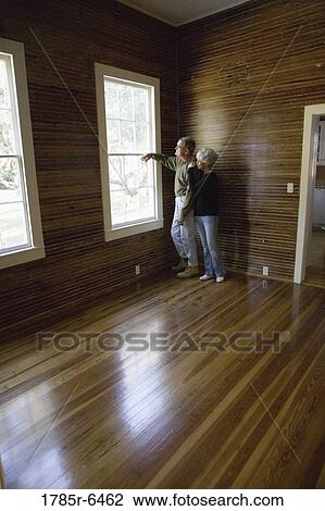 Mature couple in a darkened room leaning against window, gazing out View Large Photo Image Stock Image - Mature couple in a darkened room leaning against window, gazing out. Fotosearch