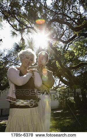 Mature couple posing under oak trees View Large Photo Image Stock Photo - Mature couple posing under oak trees. Fotosearch