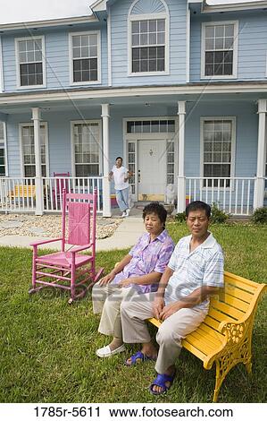 Mature couple sitting in front lawn of house, pregnant daughter on porch View Large Photo Image Stock Image - Mature couple sitting in front lawn of house, pregnant daughter on porch. Fotosearch