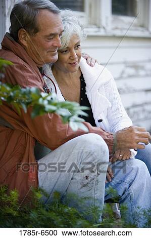 Mature couple sitting together outside View Large Photo Image Stock Image - Mature couple sitting together outside. Fotosearch