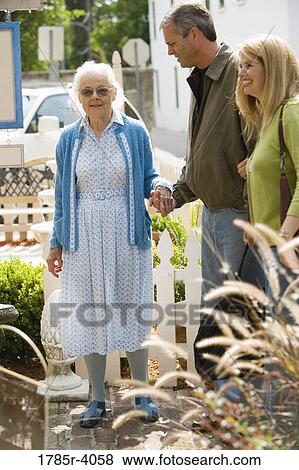 Mature couple walking with senior woman View Large Photo Image Stock Photo - Mature couple walking with senior woman. Fotosearch