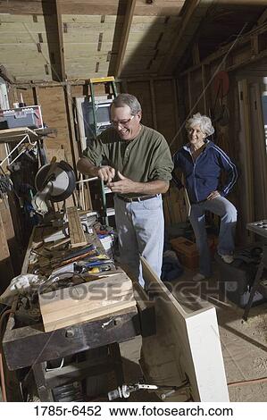 Mature man working with tools while wife watches View Large Photo Image Stock Image - Mature man working with tools while wife watches. Fotosearch