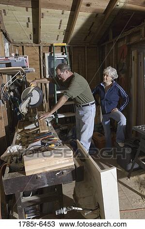 Mature man working with tools while wife watches View Large Photo Image Stock Image - Mature man working with tools while wife watches. Fotosearch