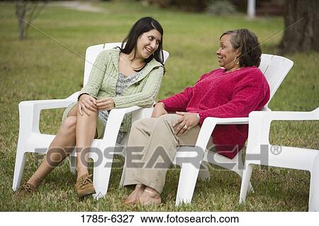 Stock Photo - Mature woman conversing with younger woman. Fotosearch