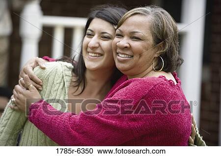 Mature woman embracing younger woman View Large Photo Image Stock Image - Mature woman embracing younger woman. Fotosearch