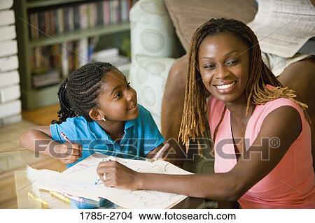 Mother and daughter coloring a book View Large Photo Image Picture - Mother and daughter coloring a book. Fotosearch