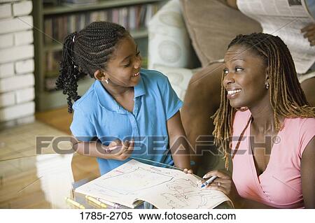 Mother and daughter coloring a book View Large Photo Image Stock Photography - Mother and daughter coloring a book. Fotosearch