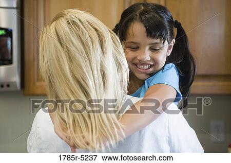 Mother carrying daughter View Large Photo Image Stock Photo - Mother carrying daughter. Fotosearch