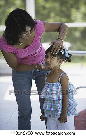 Stock Photo - Mother comforting sad daughter. Fotosearch