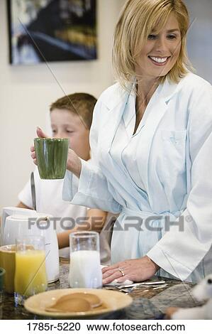 Mother having a cup of coffee View Large Photo Image Stock Image - Mother having a cup of coffee. Fotosearch