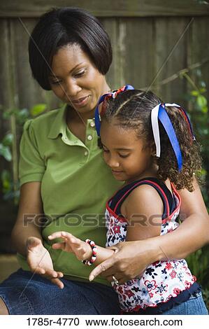 Mother hugging her daughter View Large Photo Image Stock Image - Mother hugging her daughter. Fotosearch