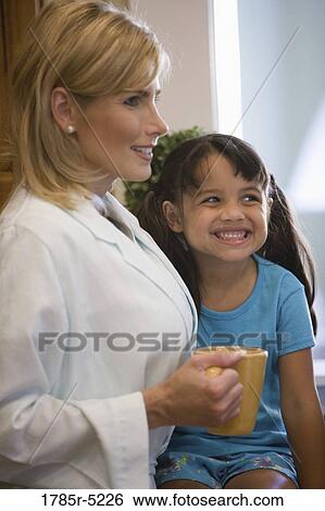 Stock Photograph - Mother with her daughter smiling. Fotosearch