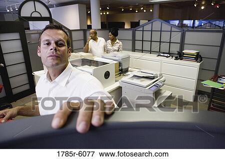 Office worker looking over cubicle wall near office equipment View Large Photo Image Stock Photo - Office worker looking over cubicle wall near office equipment. Fotosearch