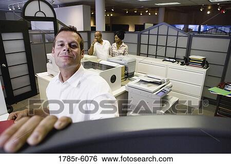 Office worker looking over cubicle wall near office equipment View Large Photo Image Stock Photograph - Office worker looking over cubicle wall near office equipment. Fotosearch
