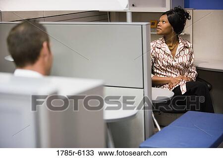 Stock Image - Office workers in cubicles. Fotosearch