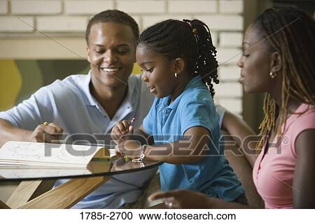 Stock Image - Parents coloring with daughter. Fotosearch