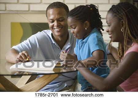 Stock Image - Parents coloring with daughter. Fotosearch