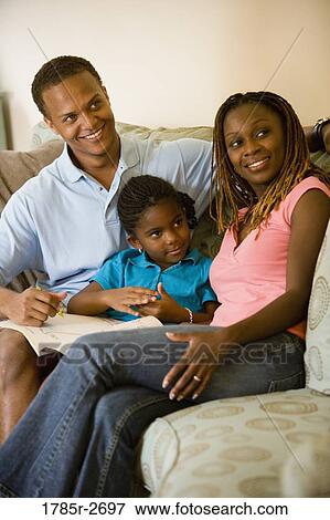 Parents reading and coloring with daughter View Large Photo Image Stock Photo - Parents reading and coloring with daughter. Fotosearch