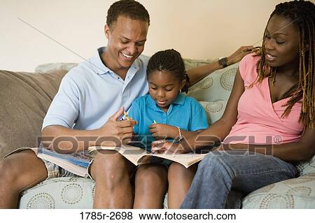 Parents reading and coloring with daughter View Large Photo Image Stock Photo - Parents reading and coloring with daughter. Fotosearch