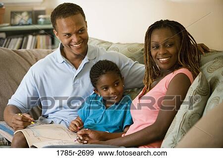 Parents reading and coloring with daughter View Large Photo Image Stock Photo - Parents reading and coloring with daughter. Fotosearch