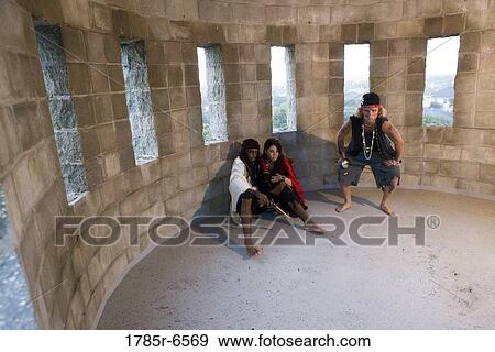 Stock Photo - Pirates sitting on the ground inside a castle turret. Fotosearch