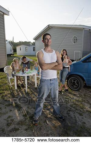 Portrait a blue-collar man with his family and friends in front of trailer homes View Large Photo Image Stock Image - Portrait a blue-collar man with his family and friends in front of trailer homes. Fotosearch