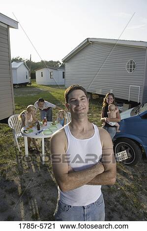 Portrait a blue-collar man with his family and friends in front of trailer homes View Large Photo Image Stock Image - Portrait a blue-collar man with his family and friends in front of trailer homes. Fotosearch