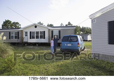 Portrait of a blue-collar couple next to old van outside trailer home View Large Photo Image Stock Image - Portrait of a blue-collar couple next to old van outside trailer home. Fotosearch
