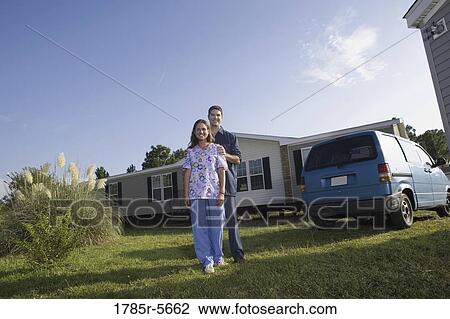 Portrait of a blue-collar couple next to old van outside trailer home View Large Photo Image Stock Image - Portrait of a blue-collar couple next to old van outside trailer home. Fotosearch