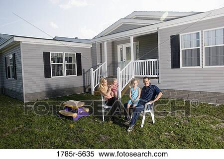 Portrait of a blue-collar family sitting in front of a trailer home View Large Photo Image Stock Photography - Portrait of a blue-collar family sitting in front of a trailer home. Fotosearch