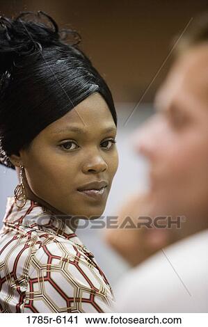 Portrait of a businesswoman glancing sideways at her colleague View Large Photo Image Stock Image - Portrait of a businesswoman glancing sideways at her colleague. Fotosearch
