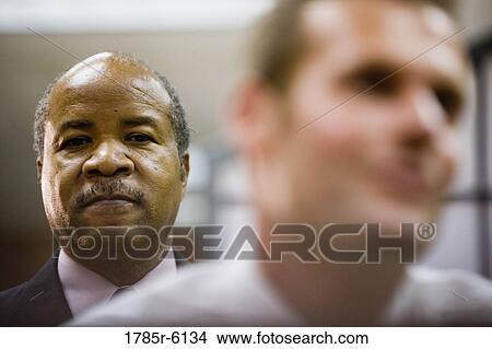 Portrait of a contemplative mature businessman with man in foreground View Large Photo Image Picture - Portrait of a contemplative mature businessman with man in foreground. Fotosearch