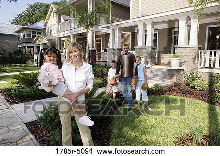 Portrait of a family in front of their house View Large Photo Image Picture - Portrait of a family in front of their house. Fotosearch