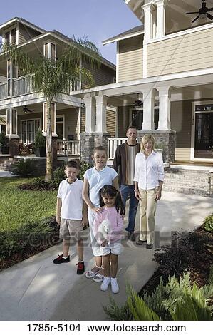 Picture - Portrait of a family in front of their house. Fotosearch
