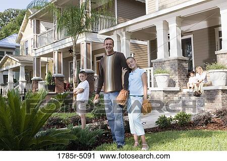 Portrait of a family in front of their house View Large Photo Image Stock Image - Portrait of a family in front of their house. Fotosearch