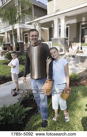 Portrait of a family in front of their house View Large Photo Image Stock Image - Portrait of a family in front of their house. Fotosearch
