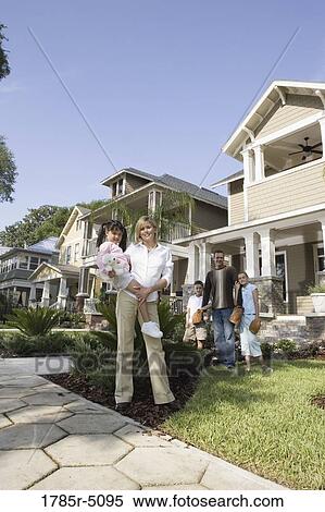 Portrait of a family in front of their house View Large Photo Image Stock Photography - Portrait of a family in front of their house. Fotosearch