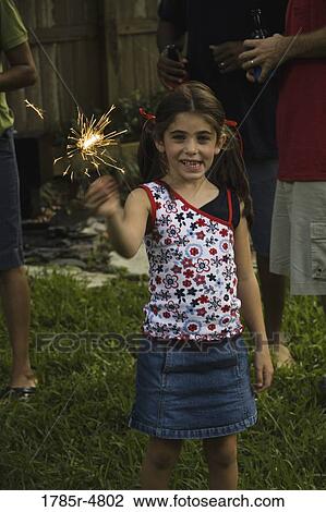 Portrait of a girl holding sparkler View Large Photo Image Stock Image - Portrait of a girl holding sparkler. Fotosearch