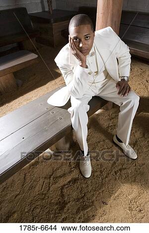 Portrait of a groom alone on a wooden bench View Large Photo Image Picture - Portrait of a groom alone on a wooden bench. Fotosearch