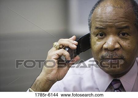 Portrait of a mature businessman using a mobile phone View Large Photo Image Picture - Portrait of a mature businessman using a mobile phone. Fotosearch